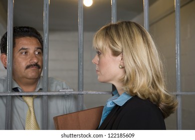 Female Lawyer Meeting With Client In Jail For Discussion