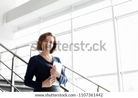 Female lawyer standing with tablet in office