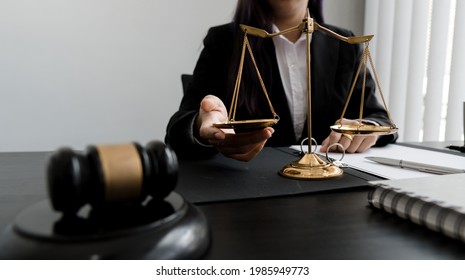 Female Lawyer Working With Contract Papers And Wooden Gavel On Table In Courtroom. Justice And Law ,attorney, Court Judge, Concept.