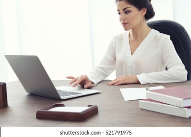 Female Lawyer Working With Laptop In Office