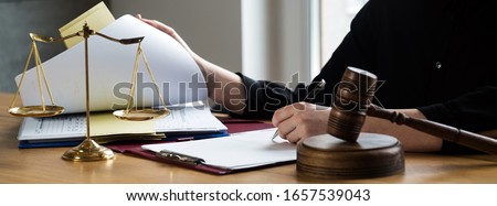  female lawyers working at the law firms. Judge gavel with scales of justice. Legal law, lawyer, advice and justice concept.