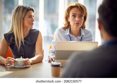 Female Leader Communicating With Her Business Team During Meeting In The Office.