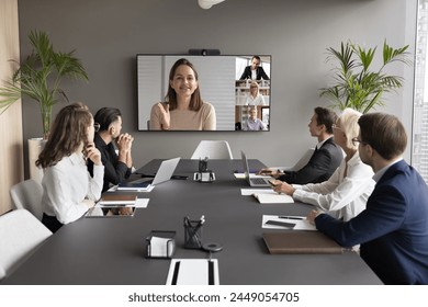 Female leader on screen, provide explanation, informing to teammates at formal virtual meeting. Group of staff listening speech of businesswoman, lead briefing event take part in videocall by business - Powered by Shutterstock