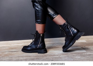 Female legs in black leather boots. New collection of winter boots for women