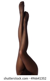 Female legs in black pantyhose on white background