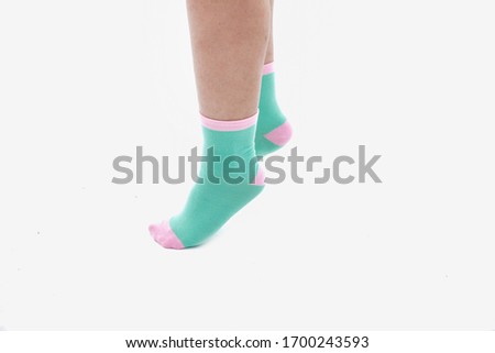 Female legs with color socks fashion on background-side view