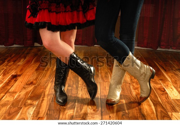 Female Legs in Cowboy Boots in a Line Dance Step on\
hardwood floor
