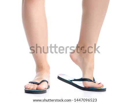 Female legs with flip flops on white background isolation