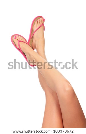 Female legs with flip-flops, isolated on white background.
