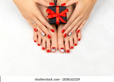 Female legs and hans with red nails on white background. Christmas sale concept.
