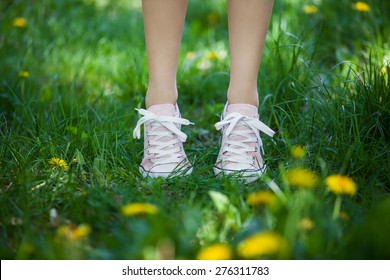 Female legs in pink shoes on the summer field - Shutterstock ID 276311783