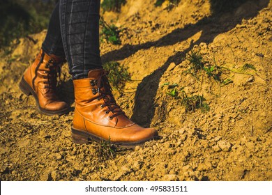 Female legs shod in Hiking boots on the forest background - Shutterstock ID 495831511