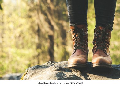 Female legs shod in Hiking boots on the forest background. Travel concept - Shutterstock ID 640897168