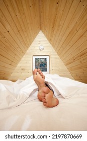 Female Legs Stick Out From Under Cosy Blanket