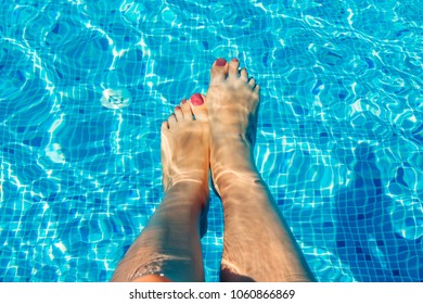 Female legs in swimming pool. All inclusive. Summer vacation concept. - Powered by Shutterstock