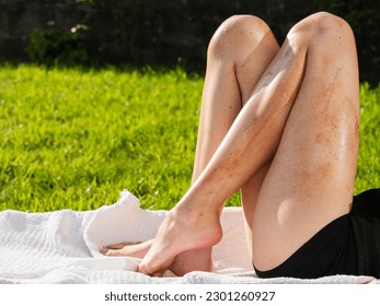 Female legs with trace of cheap fake sun tan. The model is on a sun lounger on a grass in a backyard or park. Using poor quality body care product concept. - Shutterstock ID 2301260927