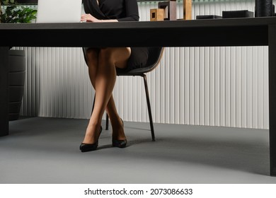 Female Legs Under The Office Desk