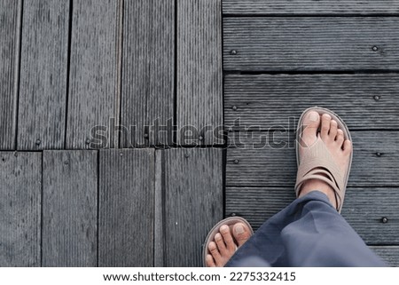 female legs walking on a wooden floor