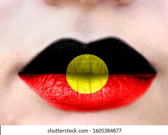 Female Lips Close Up With A Picture Flag Of Australian Aboriginal. Learning Languages.