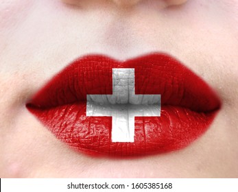 Female Lips Close Up With A Picture Flag Of Switzerland. Learning Languages.