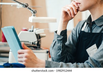 Female Local Business Woman, Tailor Working In Clothes Factory, Using Tablet Computer