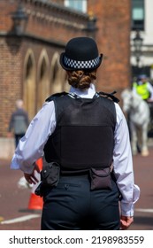 Female London Bobby. English Policewoman From Behind In A Street Of London UK