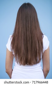 Female Long Brunette Hair, Rear View, Isolated On Blue Background