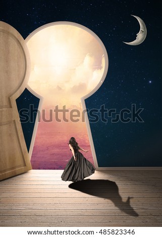 Female looking out enormous key hole door opening to a colorful cloudscape
