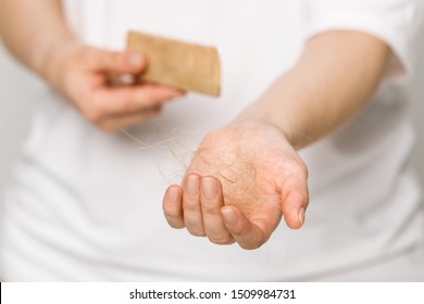 Female Losing Hair After Combing In Hairbrush In Hand. Hair Loss Problem After Covid-19 Disease, Postpartum Period, Menstrual Or Endocrine Disorder, Stress, Hormonal Disbalance Concept.