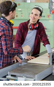 Female Machinist Smiling At Her Male Colleague