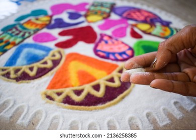 Female Making Beautiful And Colourful Happy Holi Rangoli Made At Home During Holi Festival. Holi Celebrations At House With Rangoli Colorful Powder. Rangoli Colours Kolam Art . Girl Making Rangoli.