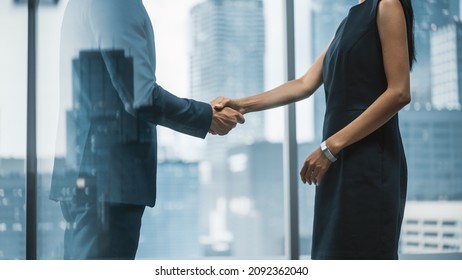 Female And Male Business Partners Meet In Office, Shake Hands. Corporate CEO And Finance Manager Have Meeting In City Office. Businesspeople Came To Discuss Real Estate Purchase And Marketing Project.