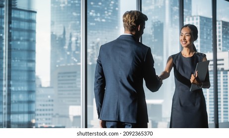 Female and Male Business Partners Meet in Office, Shake Hands. Corporate CEO and Finance Manager Have Meeting in City Office. Businesspeople Came to Discuss Real Estate Purchase and Marketing Project. - Shutterstock ID 2092365370
