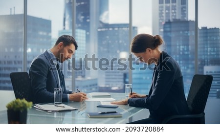 Female and Male Business Partners Sign Successful Deal Documents in Meeting Room Office. Corporate CEO and Investment Manager Agreed on a Lucrative Financial Opportunity.