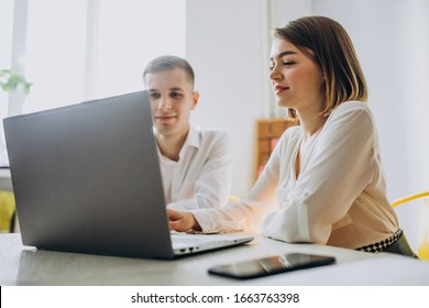 Female And Male Collegues Working In Office