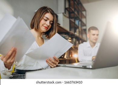 Female And Male Collegues Working In Office