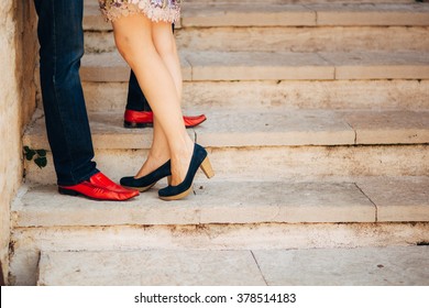 Female And Male Feet On The Stairs