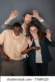 Female And Male Geek Dance While A Slick Salesman Waves