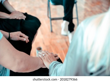 Female and male hand in hand during psychotherapy session. Cropped image, closeup.  Support, mental health, partner, consoling, partnership, relationship, confident and connection concept