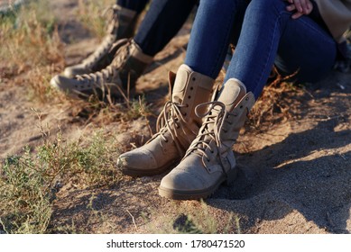 Female And Male Legs In Army Beige Boots. Outdoor Activities Couples In The Wilderness. Caucasus, Russia