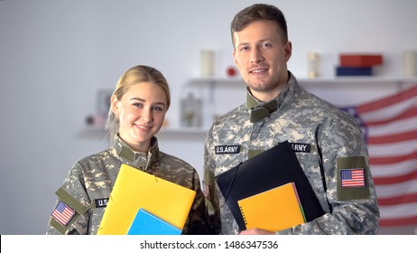Female And Male US Military Students With Folders Smiling At Camera, Education