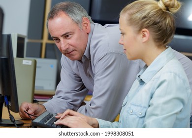 female and male worker in workshop - Powered by Shutterstock