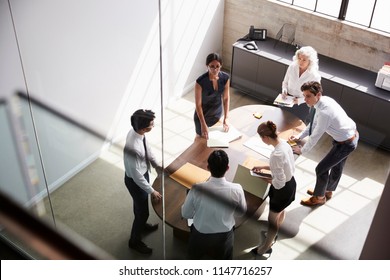 Female manager and business team in meeting, elevated view