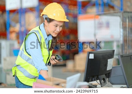 A female manager is checking inventory inside a warehouse.