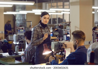 Female Manager Checking Quality Of Male Employee Shoemaker Work. People Working At Leather Footwear Factory. People Working At Plant. Manufacturing Business And Shoe Industry Workflow