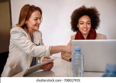 Female manager with employee make consultation about business on laptop