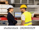 Female manager scolding employee in modern industry factory. Worker making mistake. Production manger is angry, dissatisfied for worker