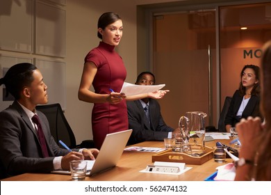 Female manager  standing with documents at business meeting