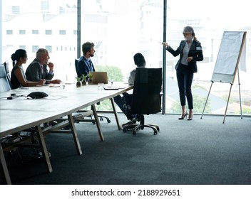 Female manager training team of businesspeople in office boardroom meeting. Professional creative leader talking in a workshop presentation, education seminar and conference with group of colleagues - Shutterstock ID 2188929651