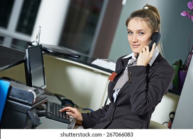 Female Manager Worker Assistant Speakiong On Phone At Hotel Reception